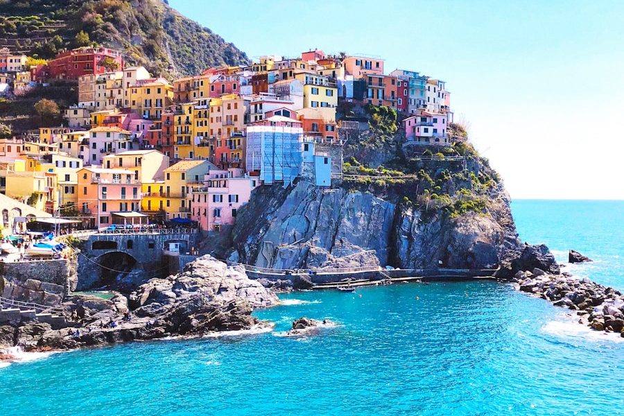 houses on mountain beside sea during daytime