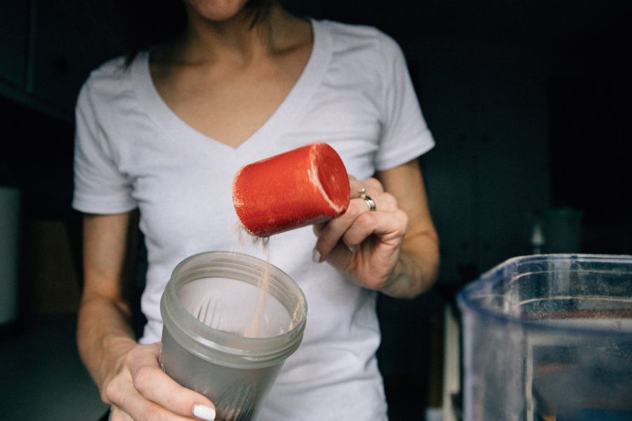 woman in white crew neck t-shirt holding red plastic cup